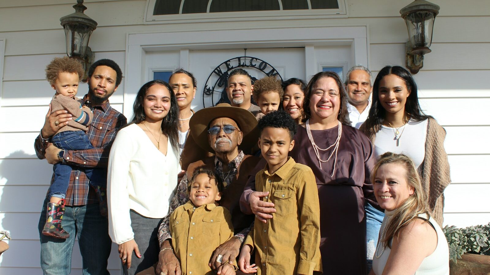 group of people standing near white building