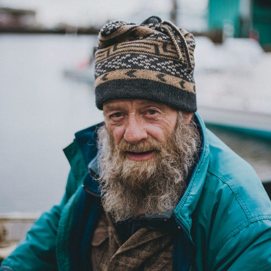 a man with a long beard wearing a hat